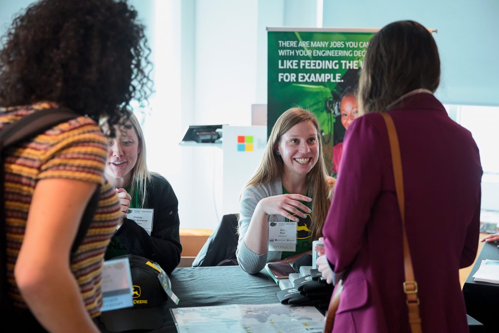 representatives from John Deere greet attendees of the 2020 Women in Data Science conference in Cambridge MA